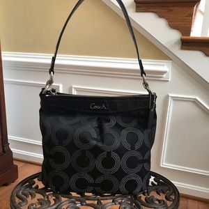 Black fabric COACH women’s handbag.